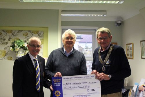 Selsey Lions Club present cheque for a donation of £500 to Selsey Community Forum Selsey Lions Club Presnts cheque to Community Forum